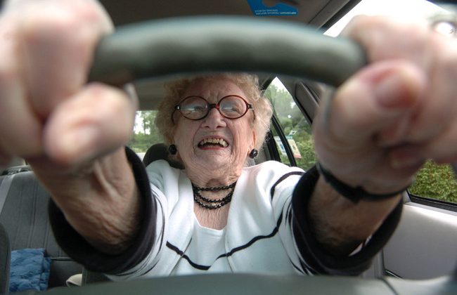 Older Lady Driver Clutching Steering Wheel