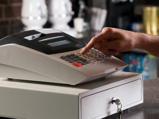 Closeup Of A Cashier's Hand Ringing Cash Register.